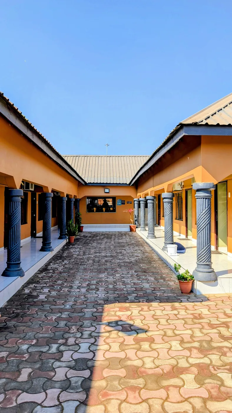 Pillared corridor leading to the guest rooms at Likaka Guest House