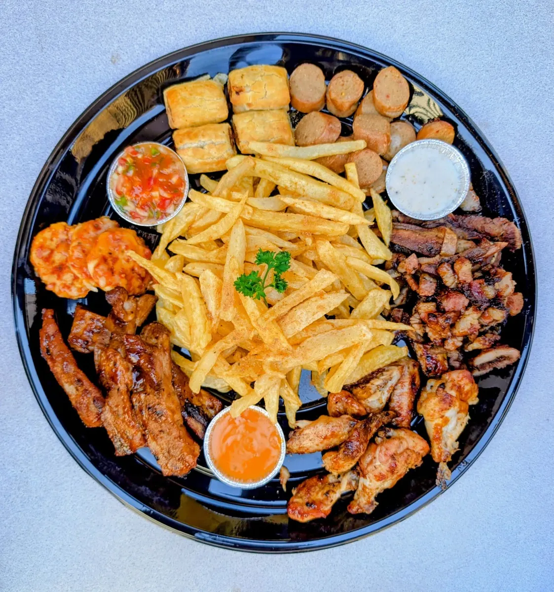 A loaded food platter at Likaka